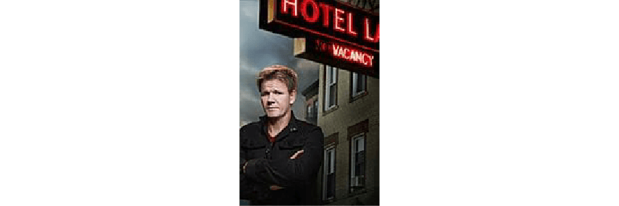 A man stands confidently in front of a hotel with a "vacancy" sign.