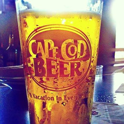 A frosty pint of Cape Cod beer sits on a bar