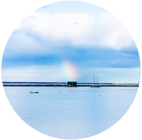 An oyster barge in Provincetown with a rainbow a top it