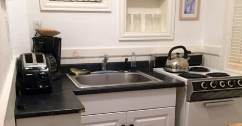 The white and black kitchenette of Lambs Retreat