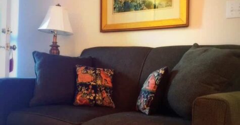 The couch under a nice framed painting